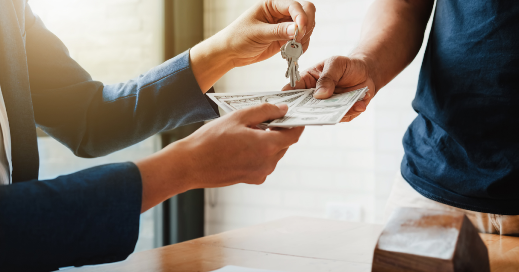 two people exchanging keys for money