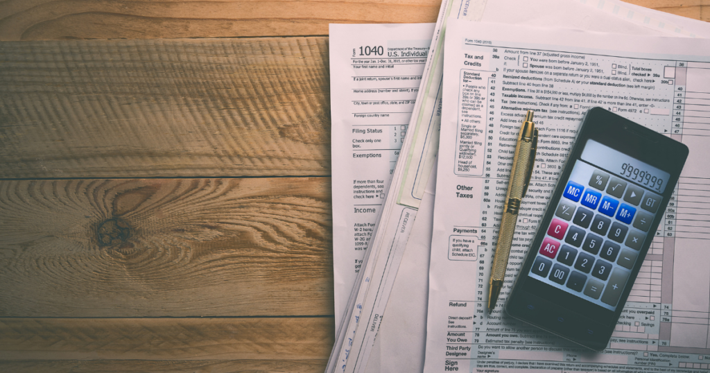 tax paperwork and a calculator on a desk